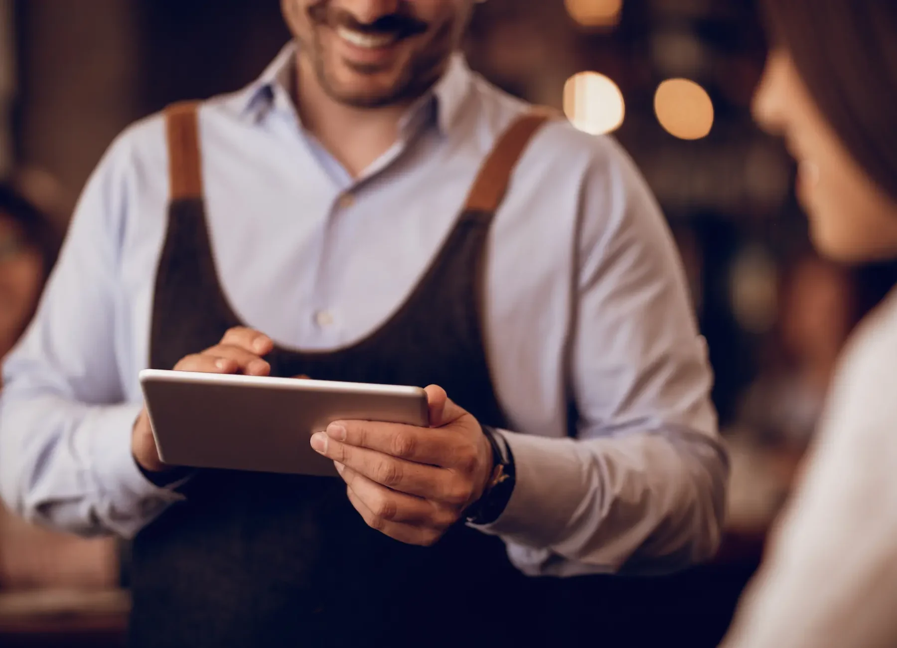 closeup-waiter-taking-order-touchpad-while-talking-guest-pub